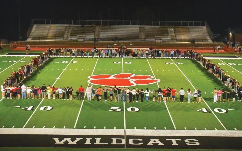 Wade Cheek/The Clayton Tribune. Students form a human rectangle at mid-field at Frank Synder Memorial Stadium to pray during the Fields of Faith event on Oct. 9.