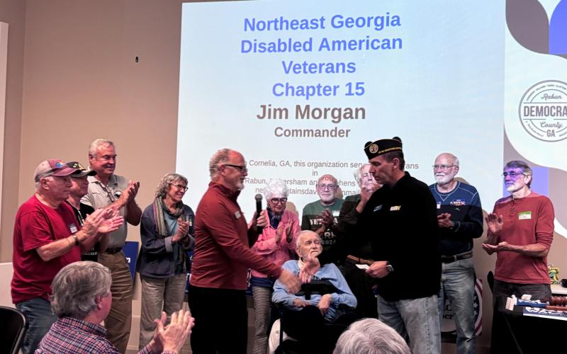 Submitted. Rabun veterans surround Chair Don Martin as he presents Jim Morgan, commander of the Northeast Georgia Mountains Disabled American Veterans (DAV) Chapter 15, a $500 donation from the Rabun County Democrats. Pictured are Ken Mosley (left); Dave Cooper; Commissioner Kent Woerner; Dr. Susan Cookson; Paulette Williams; Ray Meyer; Charles Lipthropp; David Darugh; Don Guste; and Wade Williams.