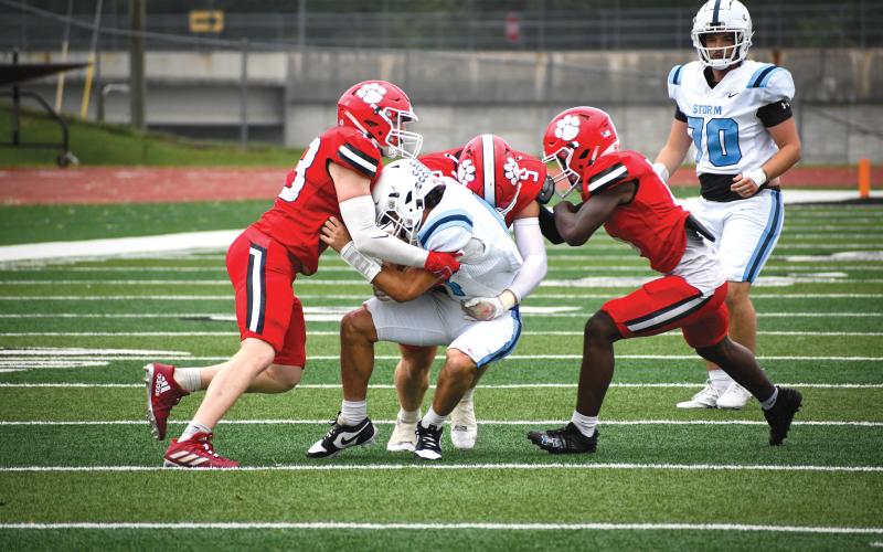 Wade Cheek/The Clayton Tribune. Linebackers Elvis Hunt (left), Dane Tyler (middle) and Jakaden Shiflet (right) make a tackle of Storm quarterback Michael Miller during Rabun County’s 50-14 win over Providence Christian Academy on Sept. 28.