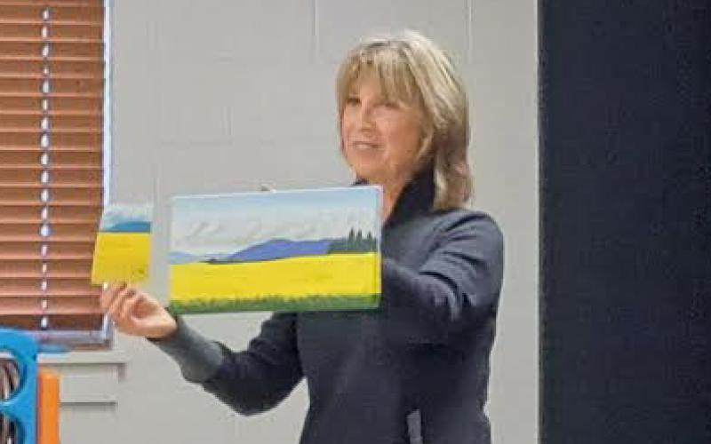 Megan Horn/The Clayton Tribune. Pam Watts took a detour from photography and decided to create paintings based on her photography. She said she was inspired by Bob Ross and presents her paintings alongside her photographs to the group. Below:  Joey Aldrich-Burel presents her painting in pastels that was inspired by Vincent Van Gogh.