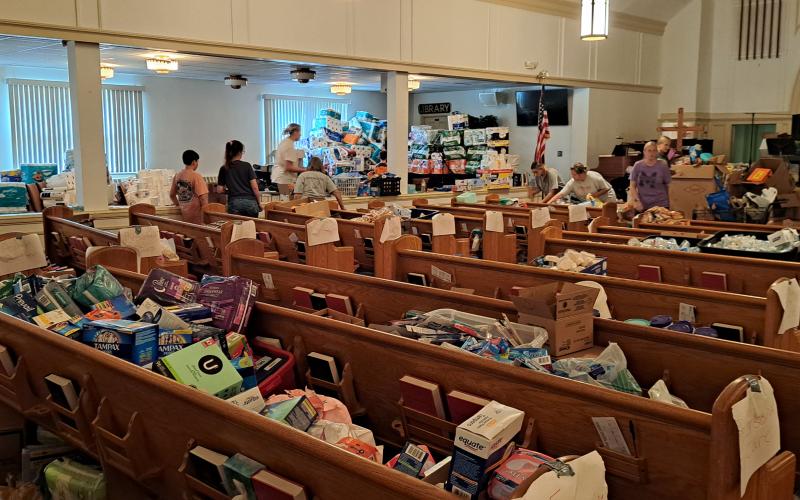 Megan Horn/The Clayton Tribune. Spruce Pine First Baptist Church with Pastor Dr. Rocky Branch organized a food distribution and area where community members and first responders can take showers, grab supplies and eat hot meals. Branch said that the plan is to have the location set up for about one month and church services will be on Sundays at 11 a.m. on the front lawn.