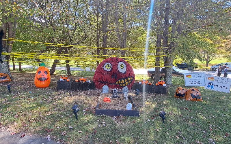 Megan Horn/The Clayton Tribune. Sky Valley Time Shares decorated this spooky graveyard scene and won third place in the Sky Valley Hay Bale Trail. Below: Veterans of Foreign Wars (VFW) Post 4570 cooked hotdogs for the community at the Sky Valley Fall Fest.