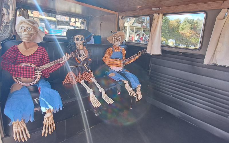 Megan Horn/The Clayton Tribune. These skeleton musicians were along for the ride in Sky Valley's Classic Car Show in this 1967 VW Bus Transporter owned by Bob Kirby. Below: Veterans of Foreign Wars (VFW) Post 4570 cooked hotdogs for the community at the Sky Valley Fall Fest.