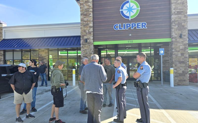Enoch Autry/The Clayton Tribune. State representatives Lauren McDonald III and Brent Cox talk with state troopers and volunteers on their stop in Clayton on Oct. 29. Below: Michael Barlow, general manager of Troncalli Subaru of Cumming, Ga., stands with Israeli Consul General Anat Sultan-Dadon outside of Clipper Petroleum in Clayton. Barlow’s business helped fund supplies that went to Western North Carolina and Eastern Tennessee. Sultan-Dadon went with the group to provide support to the victims.