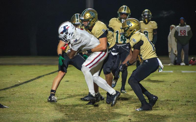 Wade Cheek/The Clayton Tribune. Rabun Gap junior Owen Madden and others join in for a late tackle as time dwindles in last week’s state title game with Providence Day. Rabun Gap won 42-39.