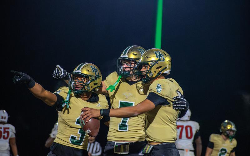Wade Cheek/The Clayton Tribune. Rabun Gap football players (from left) Anthony Quinn Jr., Marshall Pritchett and Gavin Owens point at the scoreboard as the clock winds down during the Eagles’ 42-39 state title win over Providence Day.