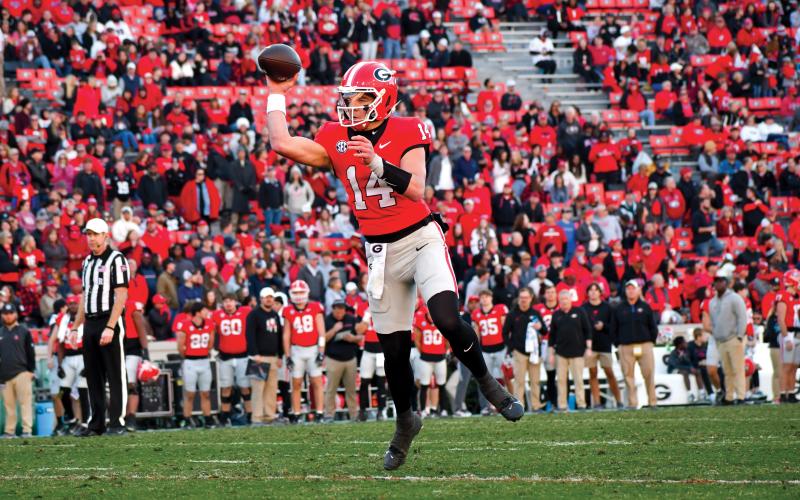 Wade Cheek/The Clayton Tribune. Gunner Stockton connects with Ben Yurosek for a nine-yard gain in the fourth quarter of Georgia’s 59-21 win.