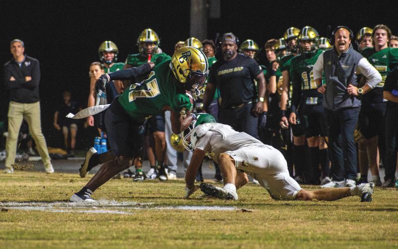 Wade Cheek/The Clayton Tribune. Junior wide receiver Joshua Buckhalter avoids a tackle from a Christ School defender to score a long touchdown. Buckhalter had 105 receiving yards on four catches with two touchdowns in the 42-7 win.