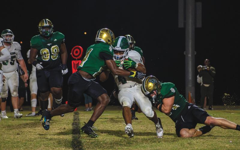 Wade Cheek/The Clayton Tribune. Seniors Callum Green and Khory Moss combine for a tackle for a loss on defense for Rabun Gap. The Eagle defense allowed just one touchdown from Christ School in its 42-7 win in the semifinal game on Nov. 8 at home.