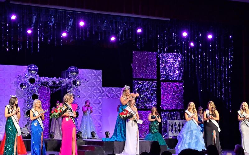 Megan Horn/The Clayton Tribune. Sayler Michelle Waldrip is crowned  2024-2025 Miss RCHS by last year’s 2023-2024 Miss RCHS winner Ashlynn York Blackwell (pictured center) on Saturday, Nov. 2. Below:  Sayler Michelle Waldrip gracefully walks across the stage at the 69th Miss RCHS Scholarship Pageant. She was crowned 2024-2025 Miss RCHS. Waldrip also was voted by the audience for the title of “Miss Sweetheart.”