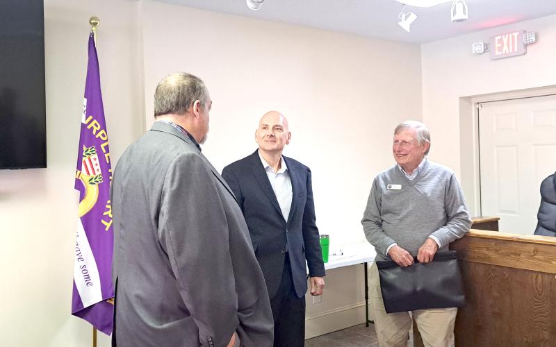 Megan Horn/The Clayton Tribune. Tim Wallis, pictured center, converses with Sky Valley city officials, City Manager Jason Streetman (left) and Council Member Jim Curtis, following Tuesday’s special called council meeting where Wallis was introduced as the new Police Chief for the Sky Valley Police Department. He is expected to start serving as Chief the first week of December.