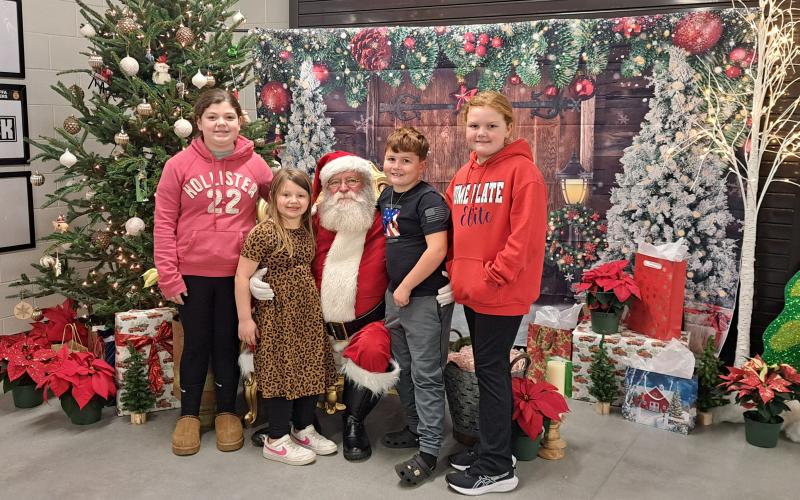 Megan Horn/The Clayton Tribune. It was a fun evening with FFA at the Rabun County Schools Agricenter “Santa on the Farm” event on Thursday, Dec. 5. Raelyn Hunnicutt, 10; Brynlee Hunnicutt, 7; Sophie Chamblee, 9; and Carter Chamblee, 7 are excited to visit Santa and tell him of their wants for Christmas.