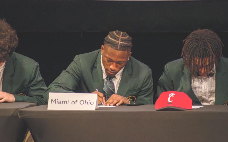 Wade Cheek/The Clayton Tribune. Rabun Gap defensive back Khory Moss signs his NLI to play football for Miami of Ohio. Moss along with multiple RGNS football players overcame injuries to continue their football journeys at the next level.