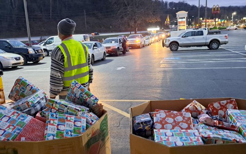 Megan Horn/The Clayton Tribune. Volunteers help distribute hundreds of gifts to children in the community during Monday’s Toy Drive at the Food Bank of Northeast Georgia.  Earlier in the day, the Teaching Kitchen had baked sugar cookies for children to decorate.