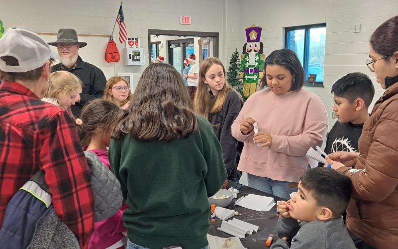 Megan Horn/The Clayton Tribune. Families enjoyed time with their children decorating holiday crafts on Dec. 5 at the Rabun County Schools Agricenter “Santa on the Farm” event hosted by Rabun County middle and high school FFA programs.