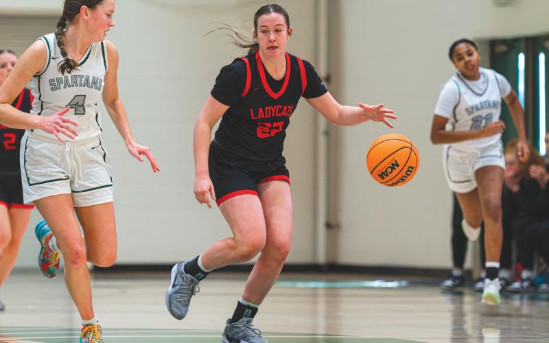 Wade Cheek/The Clayton Tribune. Senior Chloe Erlewine (22) speeds down the court with an Athens Academy defender last Saturday in a 65-32 loss to their region opponents.