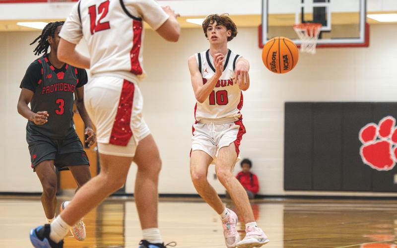 Wade Cheek/The Clayton Tribune. Senior Michael Bone completes a pass in a region bout with Providence Christian. Bone had four assists in the victory.