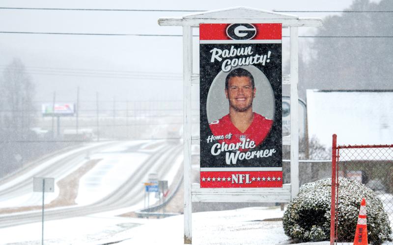 Wade Cheek/The Clayton Tribune. The colors on the sign honoring Charlie Woerner really pop against the backdrop of the white snow.