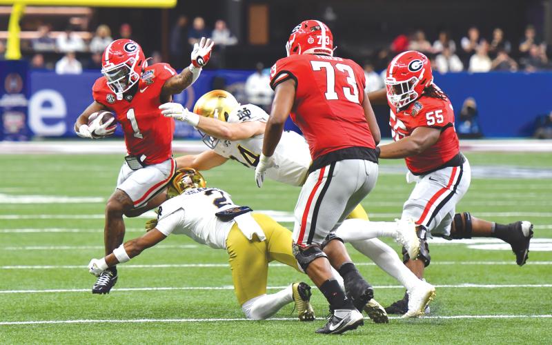 Georgia running back Trevor Etienne (1) attempts to avoid tackles from Notre Dame defenders. Georgia only rushed for 62 yards in the 23-10 loss to the Fighting Irish in the Sugar Bowl on Thursday, Jan. 2.