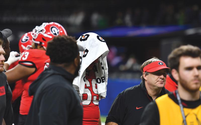 Wade Cheek/The Clayton Tribune. UGA senior offensive lineman Tate Ratledge (left) walks off of the field with head coach Kirby Smart following an emotional defeat in the Allstate Sugar Bowl on Jan. 2.