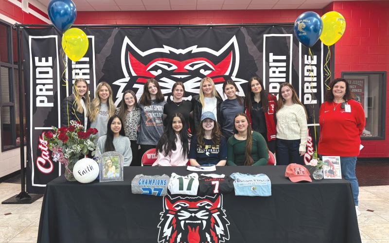 Wade Cheek/The Clayton Tribune. The 2024-25 RCHS volleyball team and others celebrated their senior setter Faith McDade on Friday, Jan. 24, as she signed her national letter of intent to play volleyball at the next level with Toccoa Falls College. McDade (seated in center) and her teammates are joined by RCHS volleyball head coach April Jones.