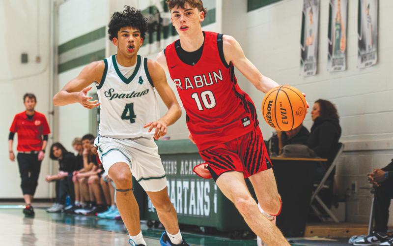 Wade Cheek/The Clayton Tribune. Senior shooting guard Michael Bone (10) drives to the basket during last Saturday’s 79-45 win over Athens Academy on the road. Bone scored 19 points in the region victory.