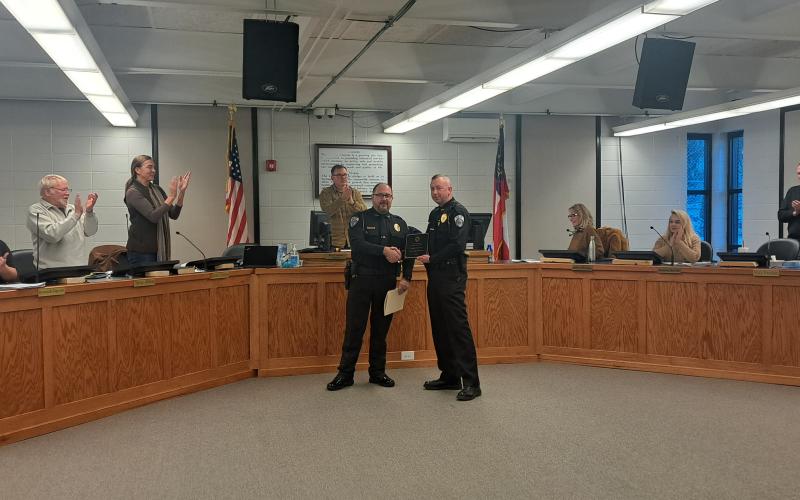 Megan Horn/The Clayton Tribune. Clayton Police Department Chief Andy Strait (left) presents Assistant Chief John Grist with the 2025 Officer of the Year award during a special ceremony at the Jan. 14 city council meeting.