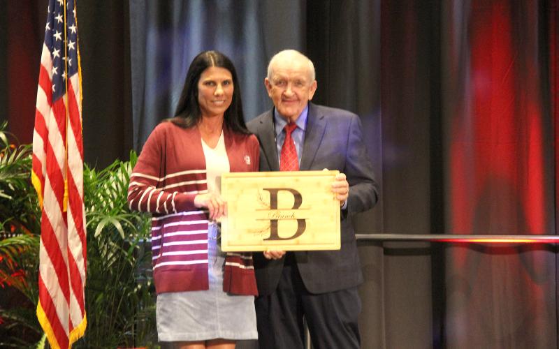 Photo submitted. Rabun County Farm Bureau member Stephanie Harden Branch accepts a gift from Georgia Farm Bureau President Tom McCall during the organization’s 87th annual convention on Jekyll Island in recognition of her serving as chairwoman of the Georgia Farm Bureau Women’s Leadership Committee in 2024.