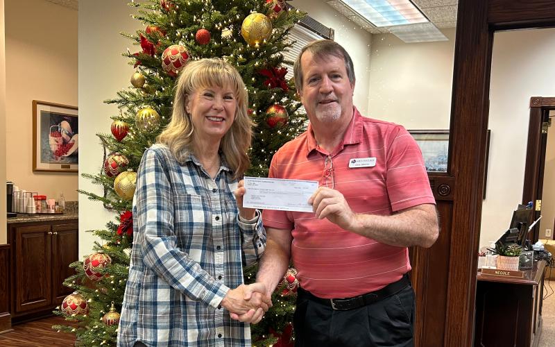 Submitted photo. Karen Bacon, Club Foundation Chair for Clayton Rotary, presents Chris DiNofrio, Treasurer for American Legion Post 220, with a check for $6,200 to support the American Legion Food Distribution Program.