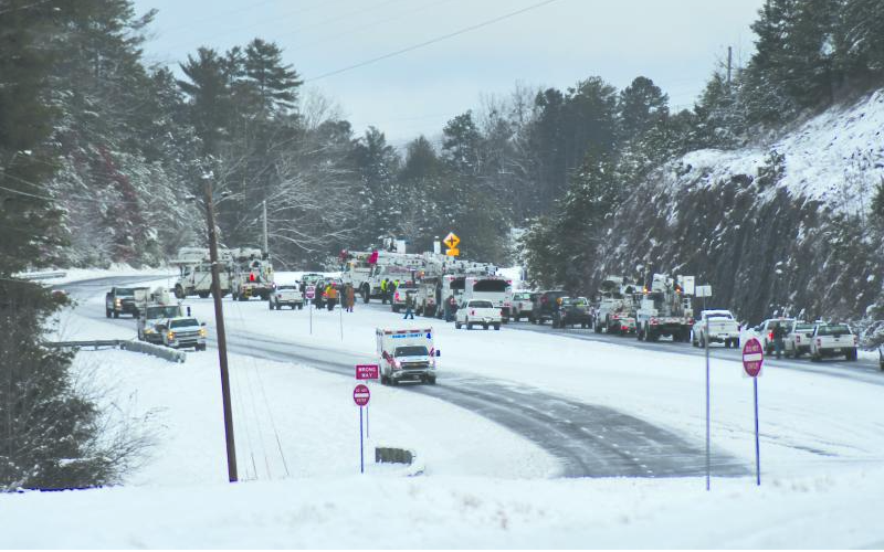 File photo/Enoch Autry/The Clayton Tribune. Utility crews work to clear Highway 441 North outside city limits of Clayton during Winter Storm Izzy in January 2022.