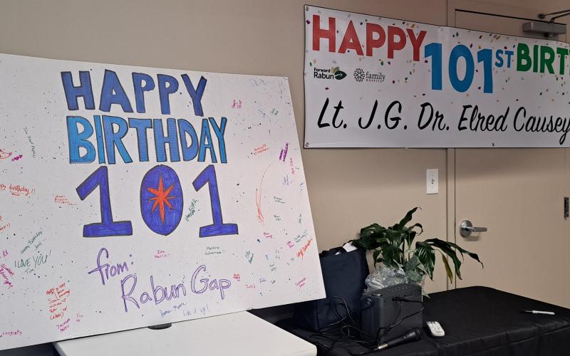 Megan Horn/The Clayton Tribune. The Community Room at the Food Bank of Northeast Georgia was decorated with red, white and blue balloons for the patriotic occasion. There were even banners and cards that said “Happy 101st Birthday.” A card signed by students at Rabun Gap-Nacoochee School was on display. Those at the cafe were encouraged to sign Causey’s banner before they left. Those at the Vet-to-vet Cafe enjoyed desserts made by Ann D’Agostino.