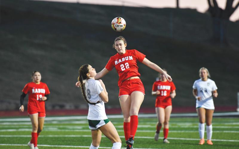 Wade Cheek/The Clayton Tribune. Senior Melanie Wells elevates to deflect a North Hall pass in Rabun’s 6-1 loss to the Trojans on Monday, Feb. 24.