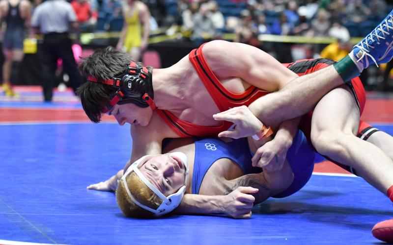 Wade Cheek/The Clayton Tribune. James Ramey (157 pounds) works to pin his Armuchee foe in the first round of the wrestling state tournament in Macon on Thursday, Feb. 13. Ramey advanced to the third round of consolation to earn 6.5 team points for Rabun County.