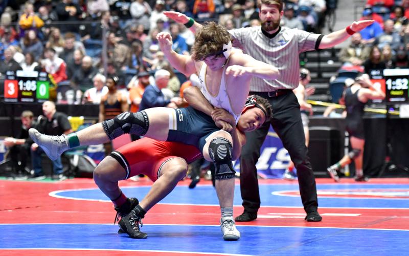 Wade Cheek/The Clayton Tribune. Junior 175-pound wrestler Shaun Fruster nabs a takedown in his opening match of this year’s GHSA Traditional Wrestling State Championship on Thursday, Feb. 13. Fruster was one of five Rabun grapplers to qualify for the state tournament.