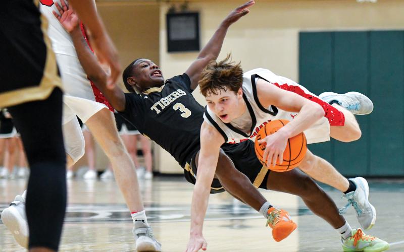 Wade Cheek/The Clayton Tribune. Junior guard Huey Blalock took some hard falls in last Friday’s region championship game against Commerce High School. Blalock fouled-out in the fourth quarter but still finished the game with 20 points.