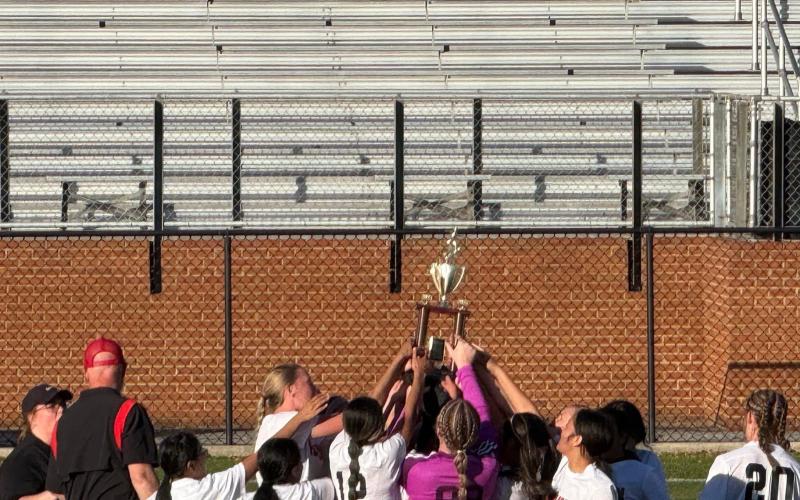 Submitted. The Rabun County Middle School girls soccer team hoists up their championship trophy just after defeating Habersham 2-1 in the championship game on Saturday, March 22.