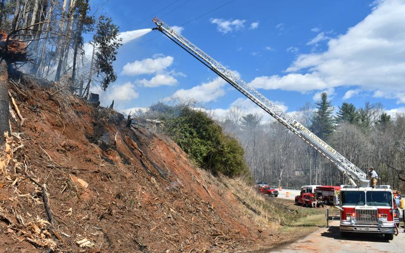 Megan Horn/The Clayton Tribune. Rabun County Fire Services utilized Ladder 1 to help contain a brush fire on Clayburne Street at Highway 441 in Clayton on March 25.