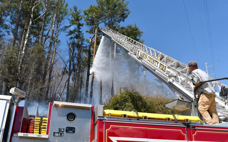 Megan Horn/The Clayton Tribune. Josh Bleckley, Rabun County Fire Services Station 2 Captain, operates Ladder 1 for a brush fire on Clayburne Street in Clayton on March 25.