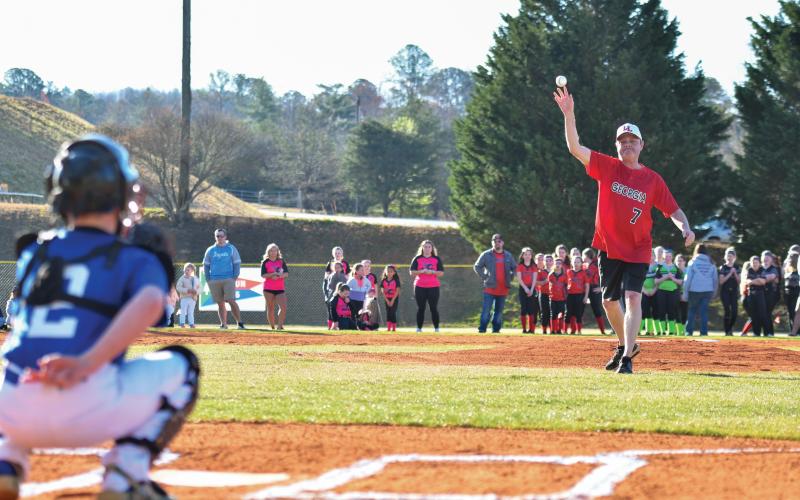 Wade Cheek/The Clayton Tribune. Georgia Little League District 7 Administrator Jeremy Haley throws out the first pitch of the Rabun County Little League season, kicking off a day of fun on Saturday, March 22.