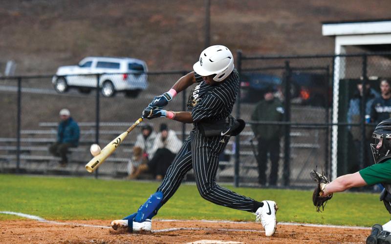 Wade Cheek/The Clayton Tribune. Senior second baseman Denajh Williams strips a base hit into the outfield in Rabun Gap’s 19-0 win over Tallulah Falls earlier this season.