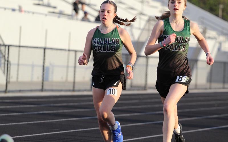 TFS Athletics. Tallulah Falls girls track and field team members Olivia Henderson and Mary Kate Ball complete a lap around the East Jackson track.
