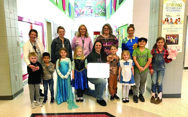 Photo courtesy Rabun County Schools.  Pictured are Back row: Mary Dunham, pre-k teacher, (left); Rachel Dixon, first grade teacher; Jamie Guffie, kindergarten teacher; Laura Welborn, kindergarten teacher; and Heather Stockton, second grade teacher. Front row: Drake Dillard, Jason Bohorquez Hernandez, Ansley Clay, Tori Burt, Principal Carla Truelove, Laith Worley, Lilly Bray, Isaiah Gordon and Rhys Coalley.