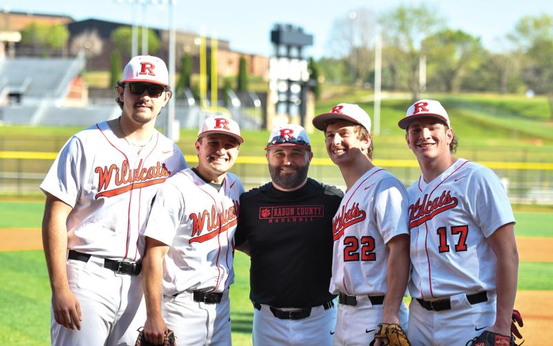 Wade Cheek/The Clayton Tribune. Rabun baseball’s 2025 seniors stand with head coach Wesley Satterfield (center) ahead of their region win over Athens Academy on Tuesday, April 8. This year’s senior class includes (from left) Michael Johnson, Parker Smith, Carver Jarrard and Elvis Hunt.