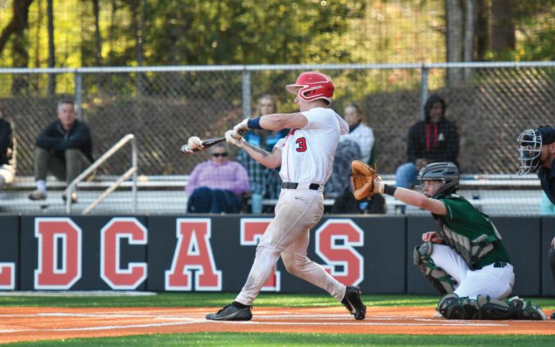 Wade Cheek/The Clayton Tribune. Wildcat junior catcher Noah English squares up a pitch to drive in a baserunner in Tuesday’s 8-2 win over Athens Academy.