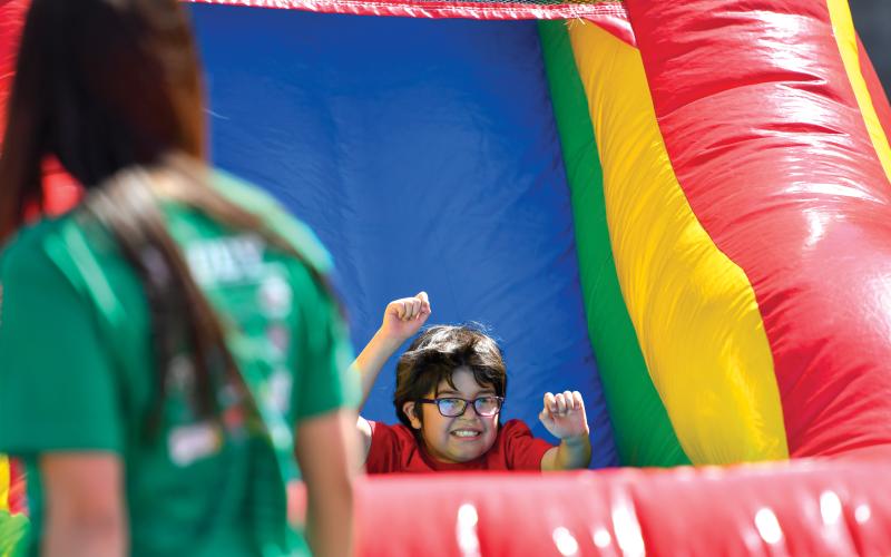 Wade Cheek/The Clayton Tribune. Winter Barcenas of Rabun County Primary School slides down one of the multiple inflatables that were available at this year’s Rabun County Special Olympics.