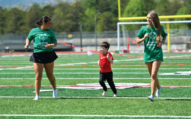 Wade Cheek/The Clayton Tribune. RCHS buddies Bailey and Ella Weber had a great time with their athlete Kooper Coalley at last week’s Rabun County Special Olympics.