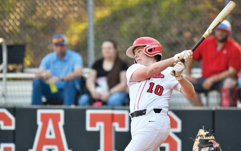 Wade Cheek/The Clayton Tribune. RCHS freshman third baseman Baylor Potts lines a ball in play during an 8-6 win over Oglethorpe County for the Wildcats (20-9).