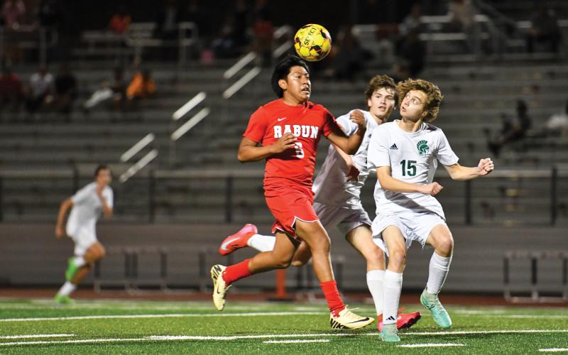 Wade Cheek/The Clayton Tribune. Junior forward Christian Avila strides down the field amid defense from Athens Academy in Thursday’s 1-0 loss to the Spartans. RCHS has one final game (Habersham) before turning its attention to the postseason.
