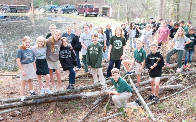 Photo courtesy of Tallulah Falls School. Tallulah Falls School fourth and fifth graders show off the pile of debris they collected during the clean up project.