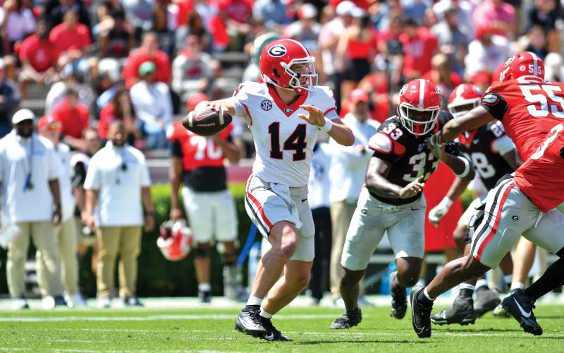Wade Cheek/The Clayton Tribune. Former Rabun County football quarterback and potential 2025 Georgia starter Gunner Stockton surveys the field for a completion during G-Day on Saturday, April 12. Stockton completed 17-of-34 passes for 309 yards and two touchdowns as his Red team defeated the Black team 34-17 in Athens.